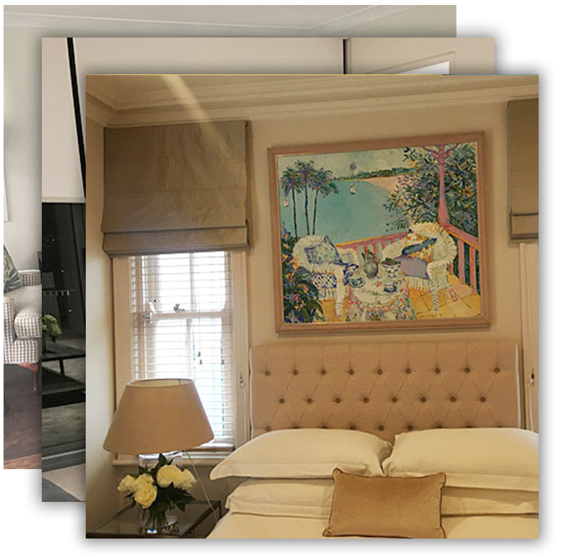 Elegant bedroom with a tufted headboard, beige linens, painting above the bed, and a lamp.